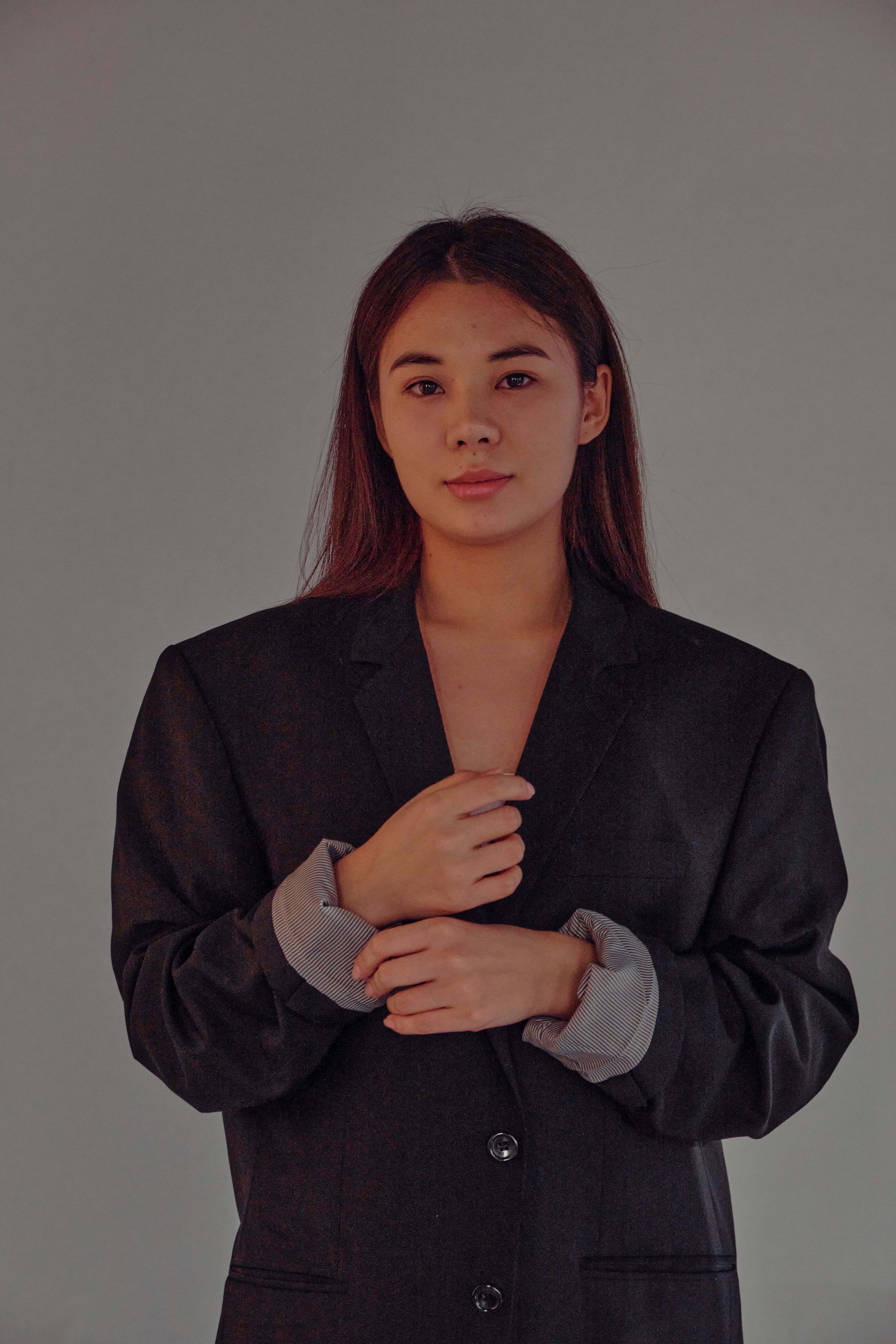 Woman in a tailored blazer wearing understated jewellery
