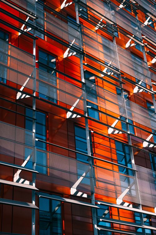 Free Low angle shot of a modern building facade with glass and metalwork in an urban setting. Stock Photo