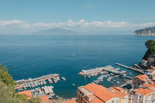 Stunning aerial view of Sorrento harbor with vivid sea and coastal landscape in Campania, Italy.