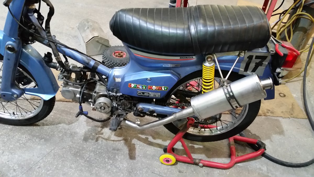 Wildfire burning near a forested hillside at dusk