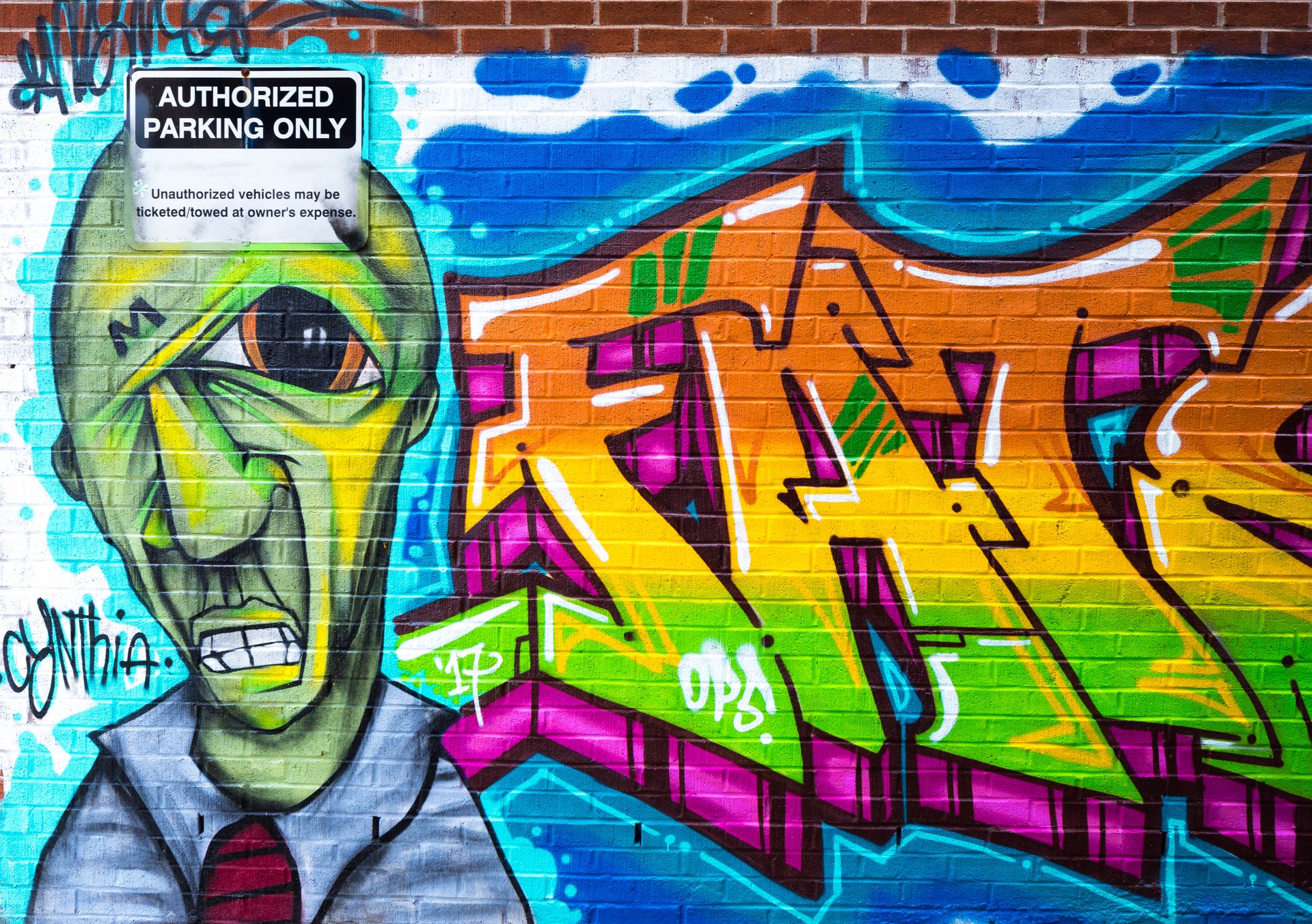 Photography of Brick Wall With Graffiti