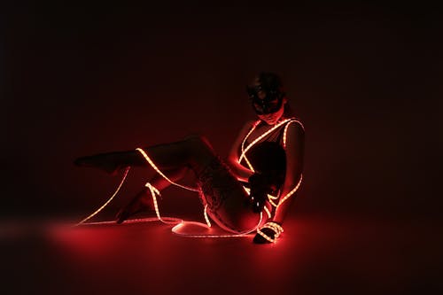 Free Photograph of a Woman Posing with Red Led Lights Stock Photo