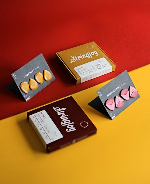 Photograph of Cards with Orange and Red Plectrums