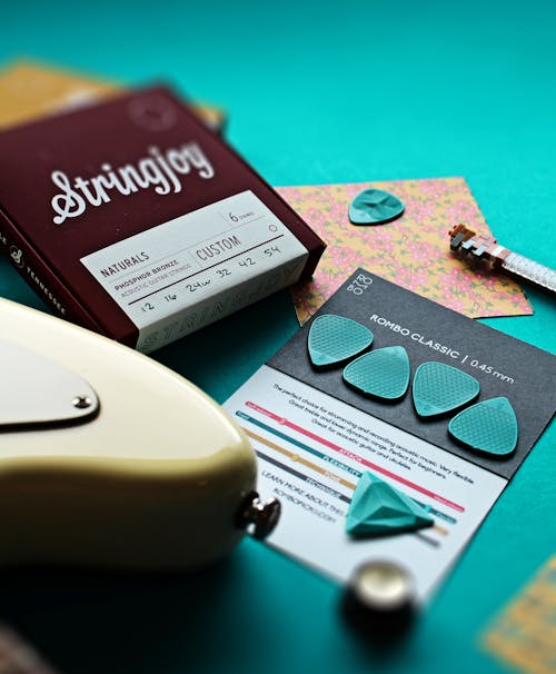 Close-Up Photograph of a Black Card with Blue Guitar Picks