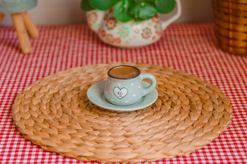 Free A Cup of Coffee on a Woven Placemat Stock Photo