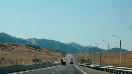 Free Long highway through mountainous terrain in Dagestan, Russia, under clear blue skies. Stock Photo