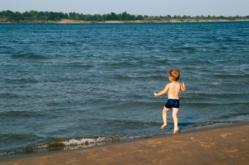 A Little Boy Walking in the Seashore