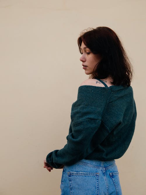 Woman in Gray Sweater and Blue Denim Jeans