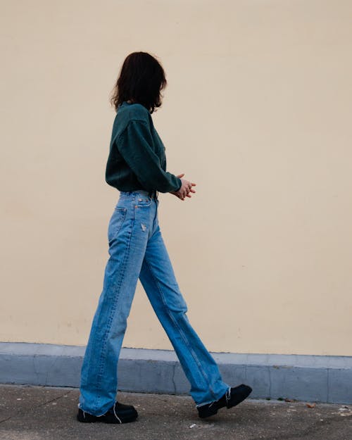 Free Woman Walking Beside a Wall Stock Photo