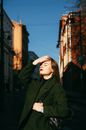 Girl in a City Exposing Her Face to the Sun 