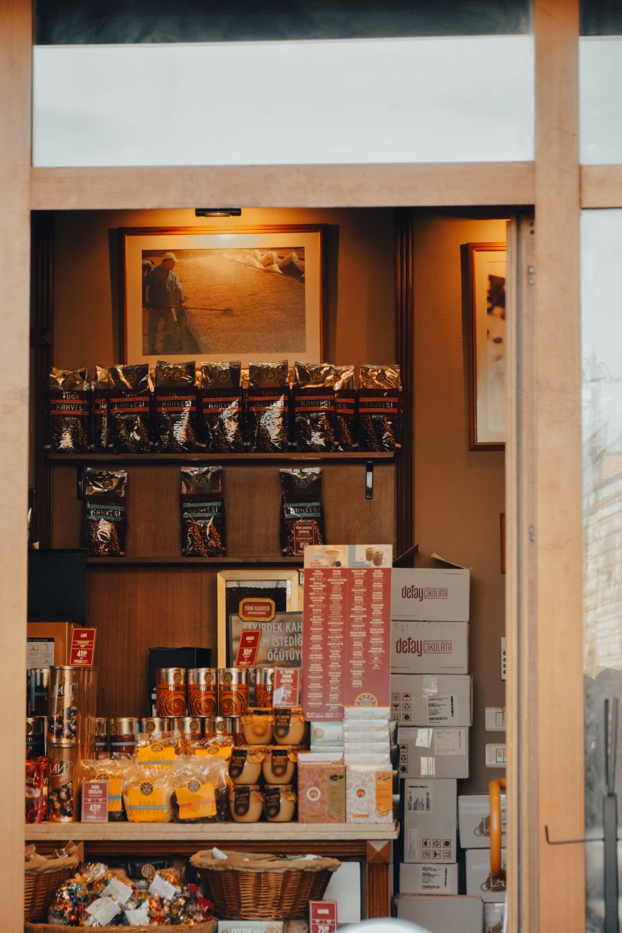 Cafe interior with product shelving, counter and warm lighting