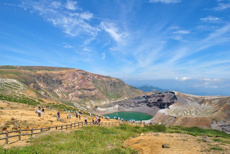 Tourists Near Lake Among Hills