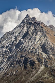Breathtaking view of a rugged Swiss mountain peak under a blue sky, perfect for nature enthusiasts.