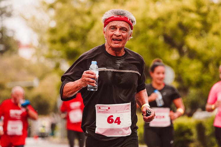 An Elderly Man Running In The Marathon 