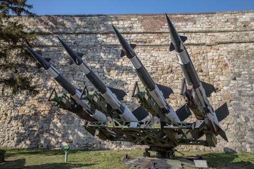 Free Missiles on Display Near a Stone Wall Stock Photo