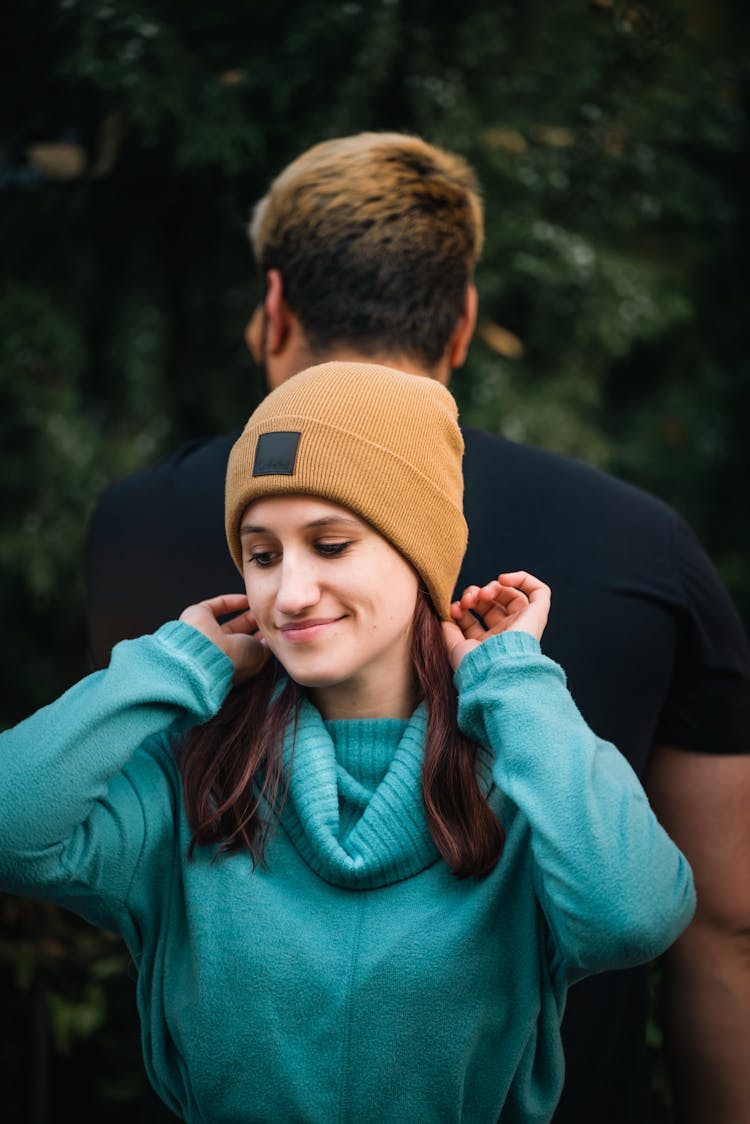 Woman In Teal Long Sleeves And Yellow Beanie