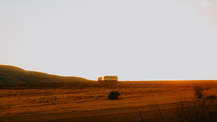 Field And Truck Behind