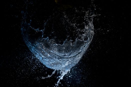 Captivating image of a water splash captured in motion on a dark background.