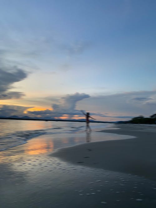 Blurred Person on Beach at Dusk