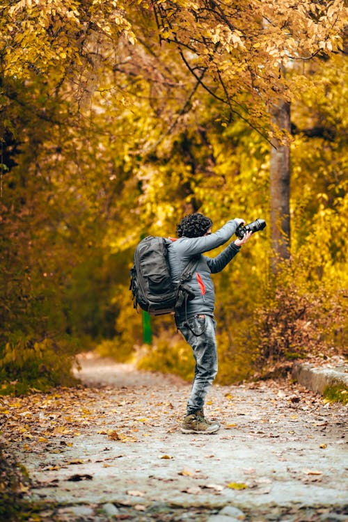 Free Man Carrying Backpack While Taking Photo Stock Photo