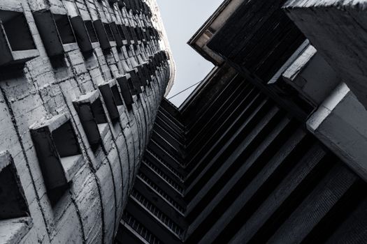 A striking grayscale image capturing the geometric patterns of urban architecture from a low angle.
