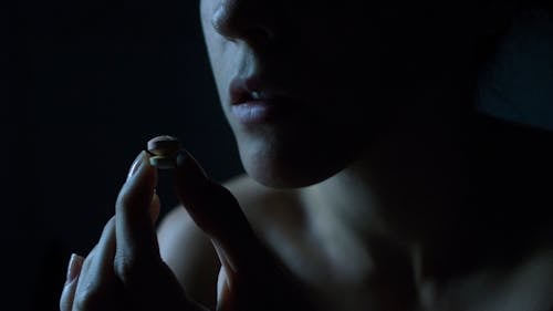 Woman Fingers Holding Pill