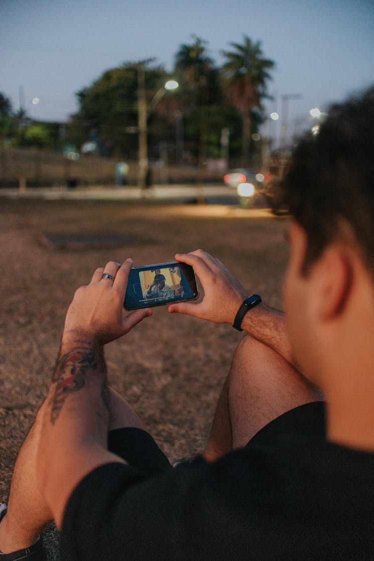 Man Watching Movie On Cellphone