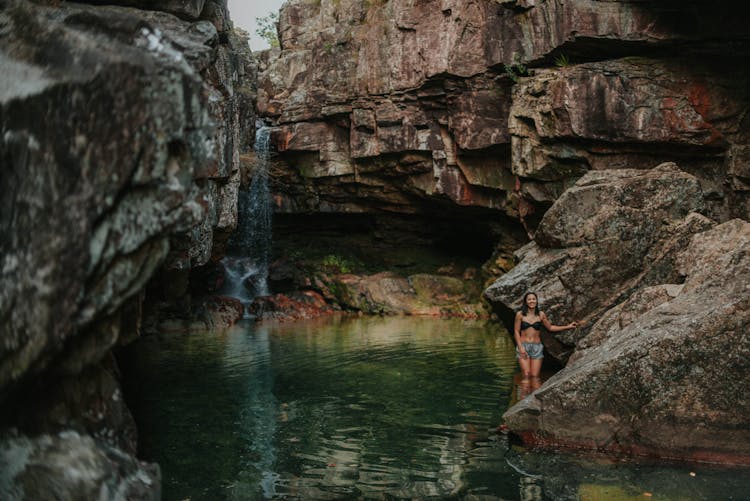 Woman In Cave With Waterfall