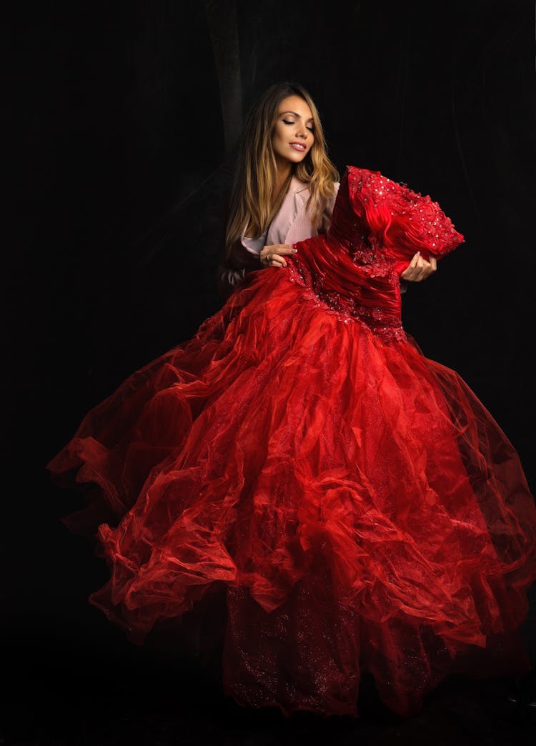 Woman Holding A Red Gown