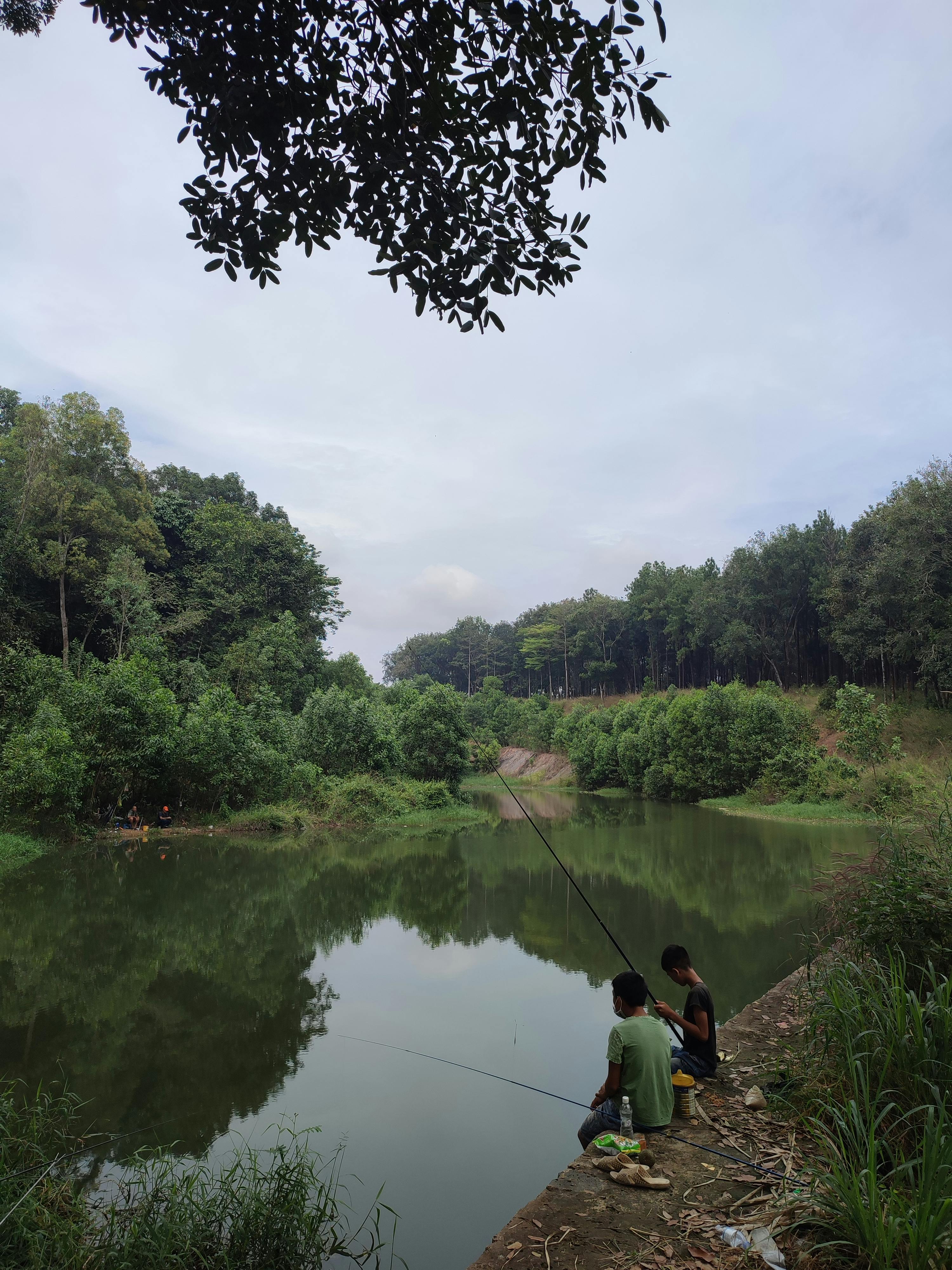 people fishing on riverbanks