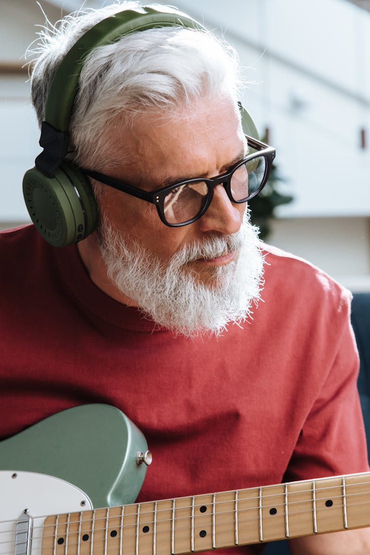 Elderly Man Playing On Electric Guitar