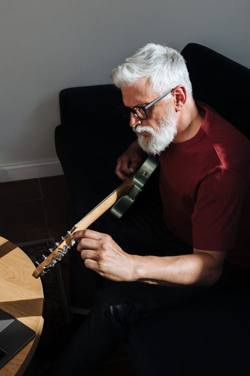 Elderly Man Playing on Electric Guitar