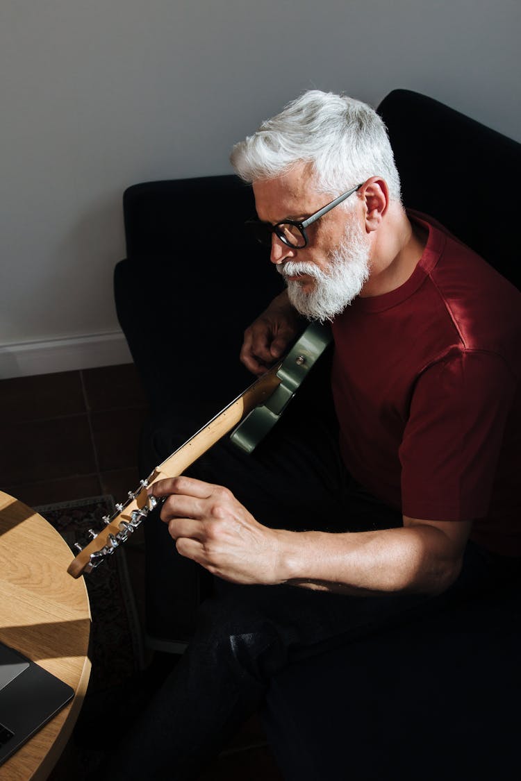 Elderly Man Playing On Electric Guitar