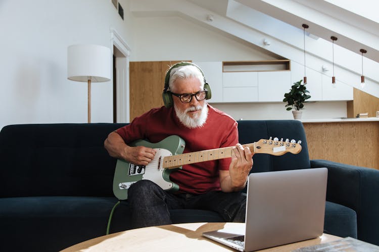 Elderly Man Playing On Electric Guitar