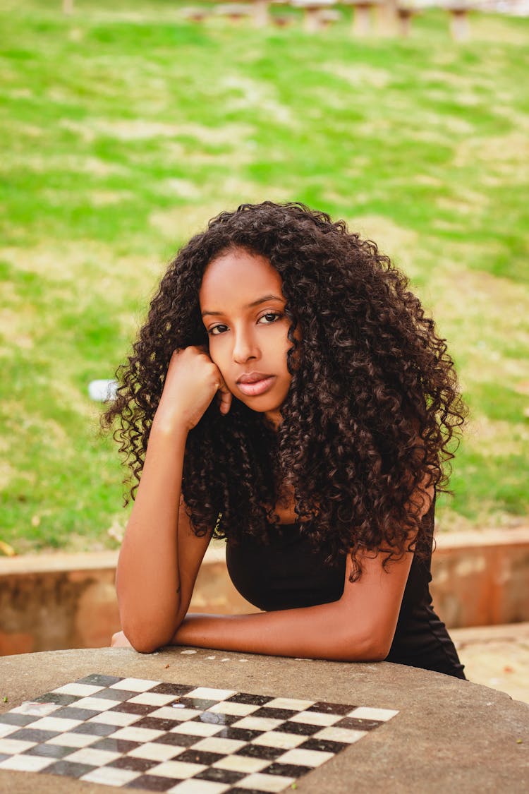 Woman Leaning On A Concrete Table