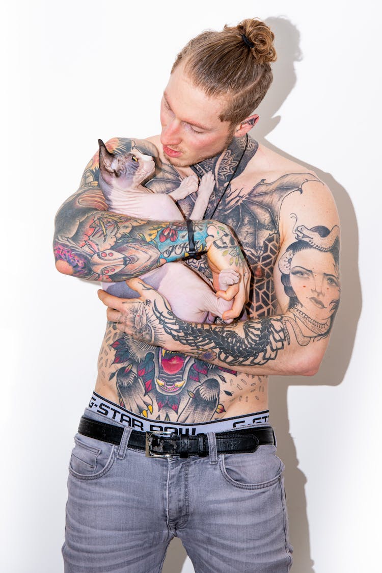 Shirtless Man Holding A Cat