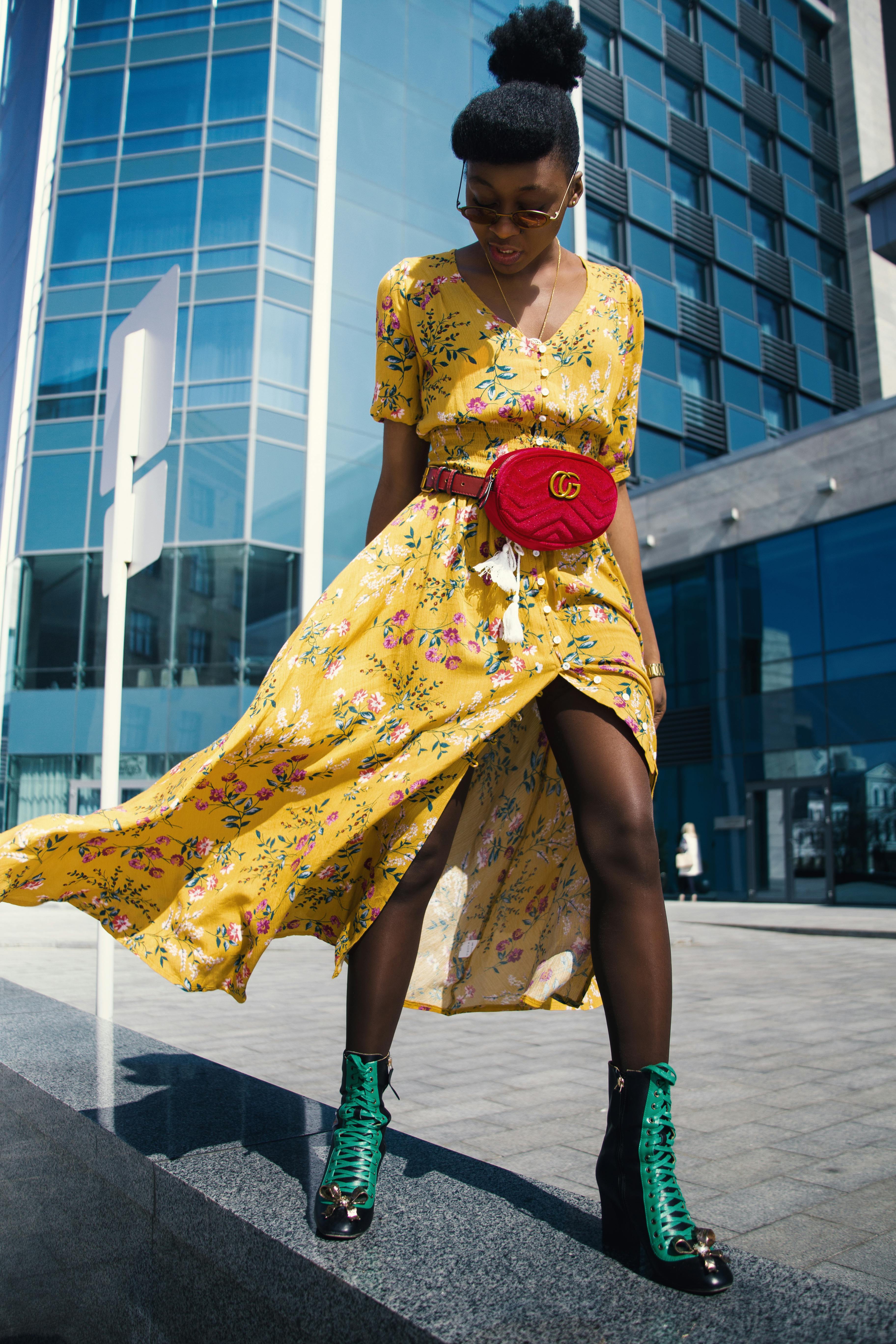 woman wearing yellow floral v neck long dress and pair of green wedge sandals