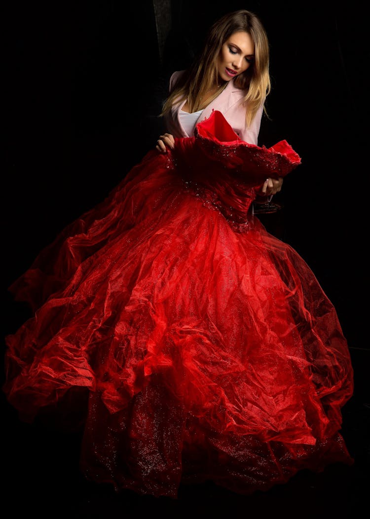 Photo Of A Woman Holding Red Gown