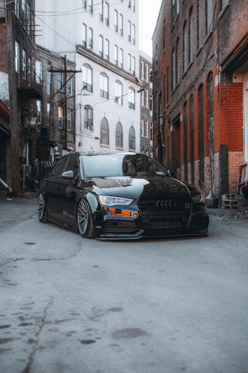 Free Black Bmw Car Parked Beside Brown Building Stock Photo