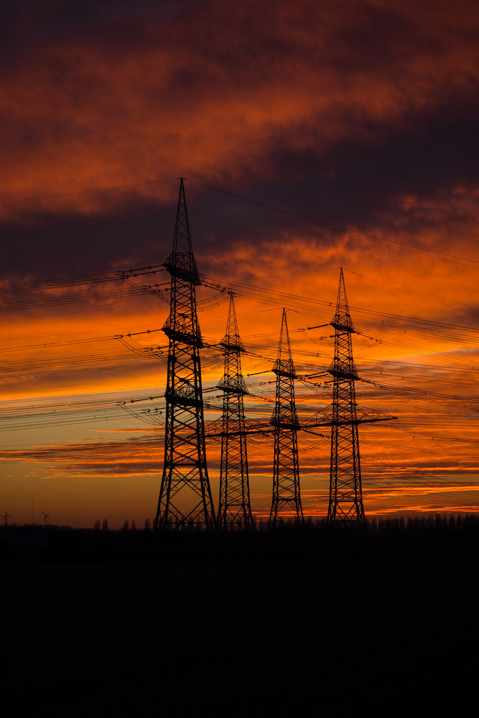 Power transmission towers at sunset