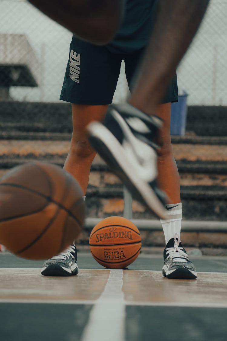 A Person In Black And White Nike Basketball Shoes