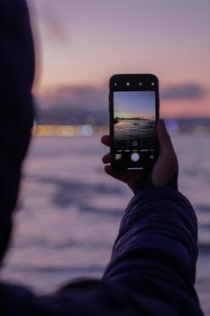 A captivating sunset viewed through a smartphone in Tangier, Morocco.