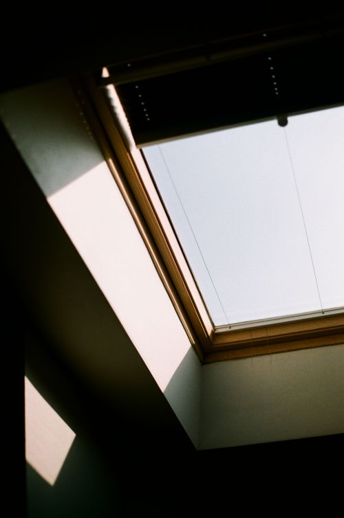 Free Close-up of a skylight casting shadows inside a room with natural sunlight. Stock Photo
