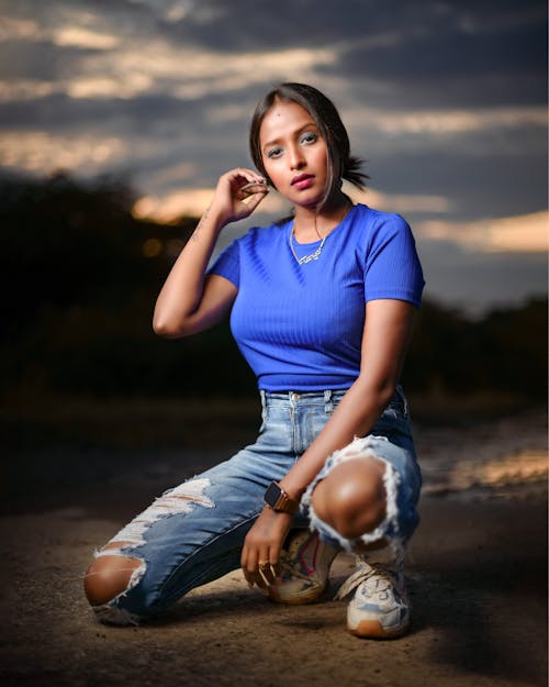 Woman in Blue Top and Denim Jeans