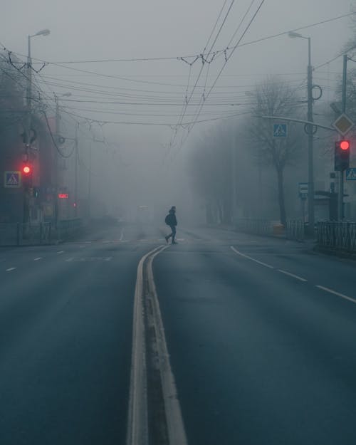 Free Man Walking Across the Road Stock Photo