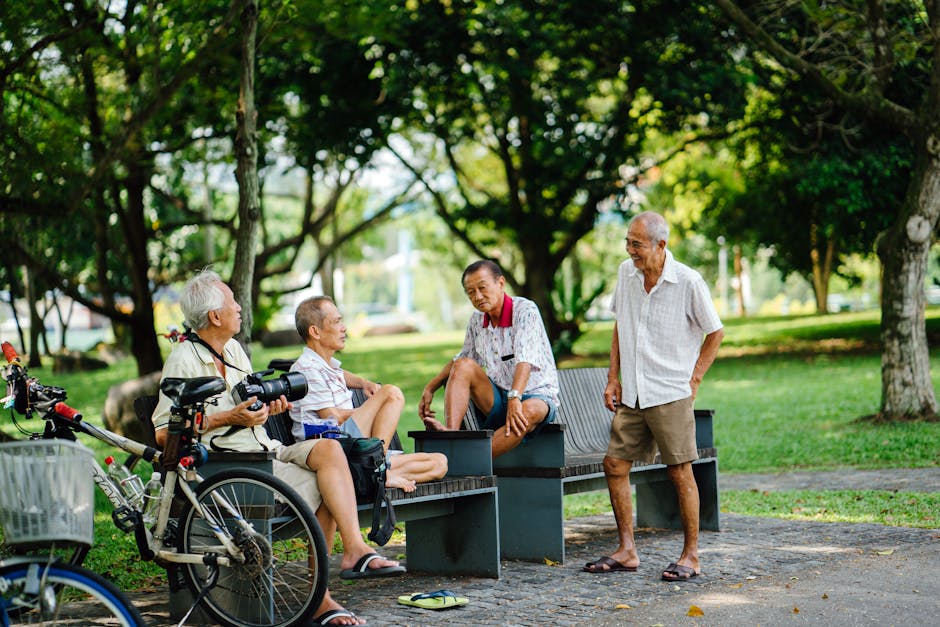 Photo of Group of Men in Sitting On Bench