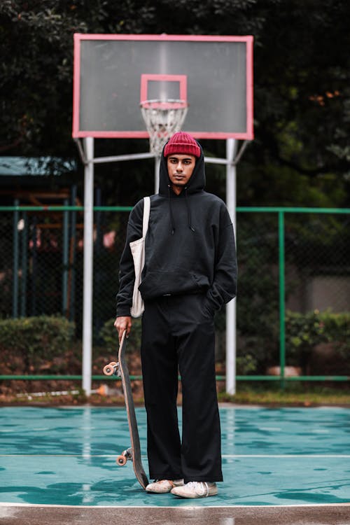 Man Holding Skateboard