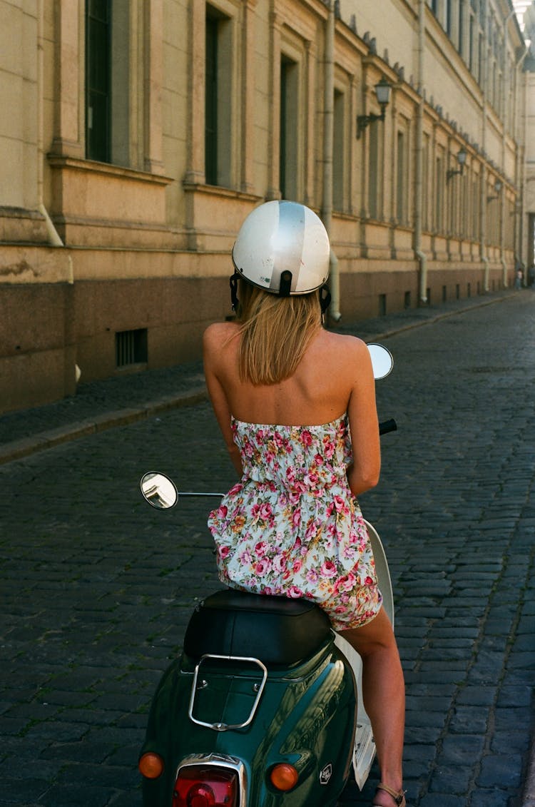 Woman Riding A Scooter