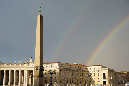 White Concrete Building Under Rainbow