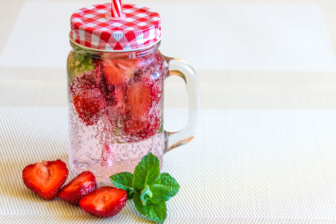 Sliced Strawberries on a Carbonated Drink 